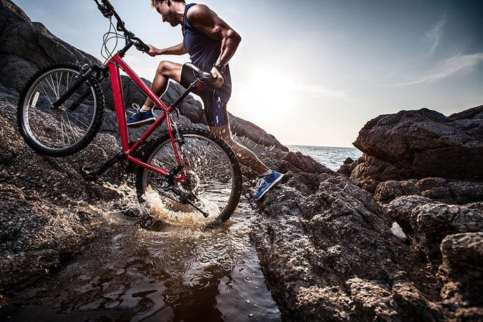 Athlete crossing rocky terrain Wall Mural Wallpaper