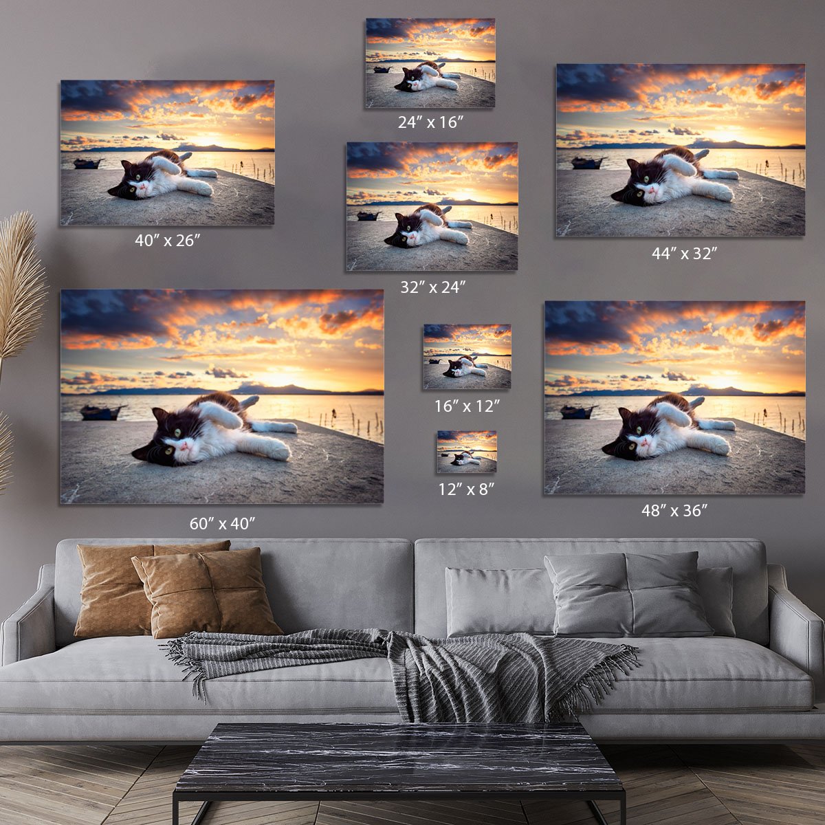 Black and white cat lying under a dramatic sunset Canvas Print or Poster