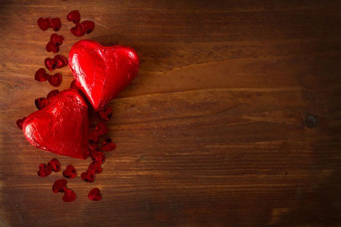 Chocolate hearts on wooden board Wall Mural Wallpaper
