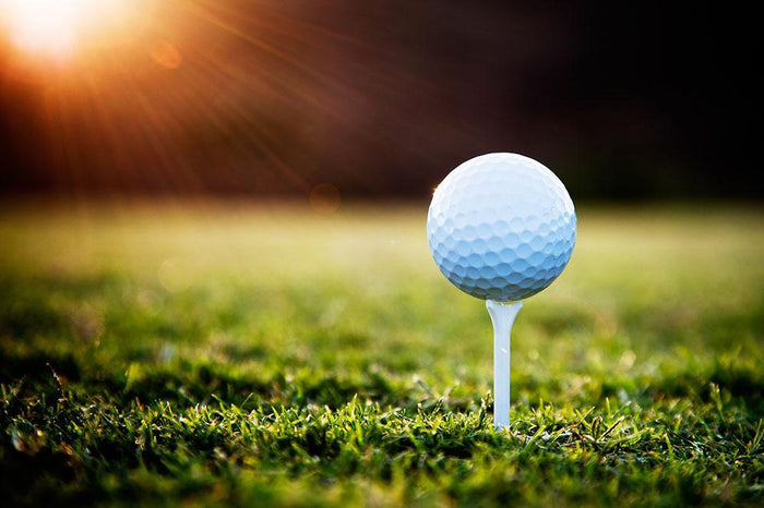 Close up of golf ball on tee Wall Mural Wallpaper