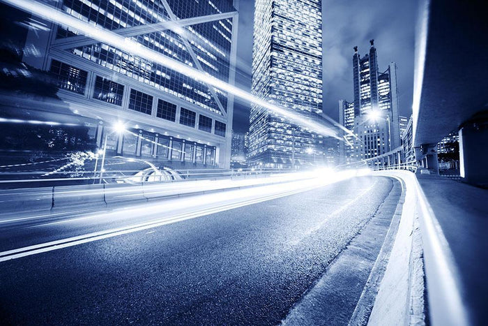 Fast moving cars lights blurred city Wall Mural Wallpaper
