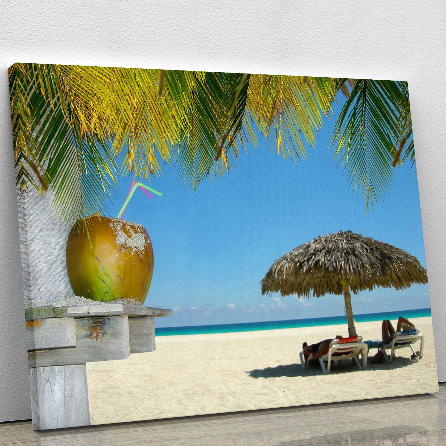 People relaxing under tropical huts with coconut Canvas Print or Poster