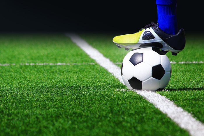 Soccer ball on field Wall Mural Wallpaper