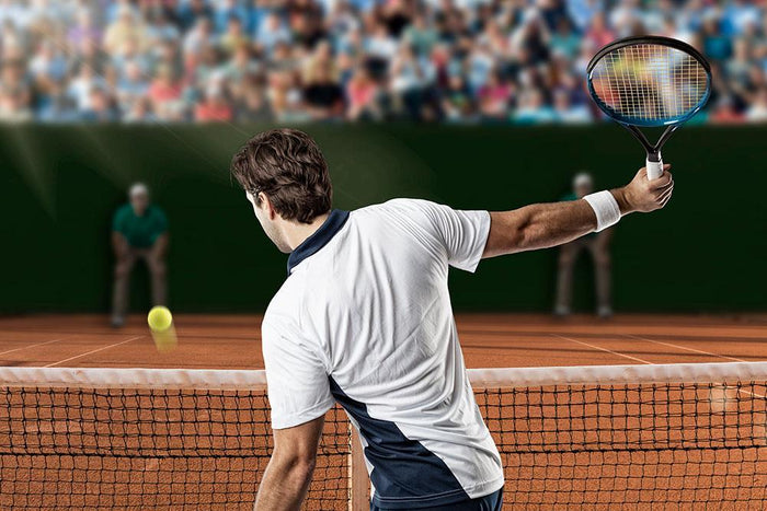 Tennis player returning a ball Wall Mural Wallpaper