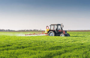 Tractor spraying wheat field Wall Mural Wallpaper - Canvas Art Rocks - 1