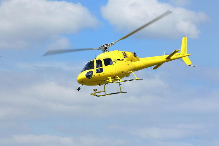 Yellow helicopter in the air Wall Mural Wallpaper