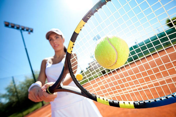 Young woman playing tennis Wall Mural Wallpaper